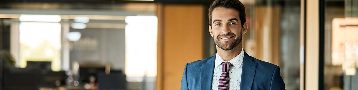A man wearing a suit in an office.