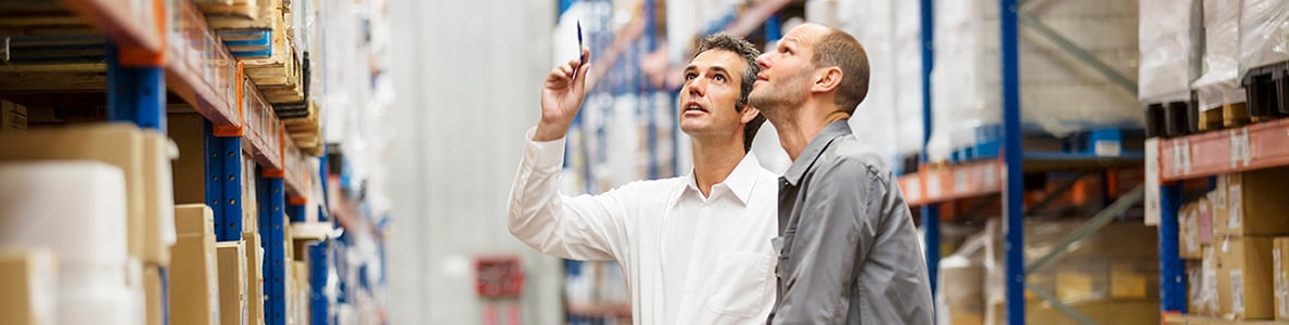Two men in a wholesale warehouse.