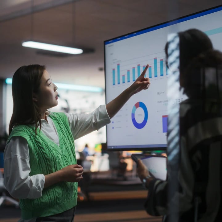 A women looking at a computer screen looking at a visual of data.