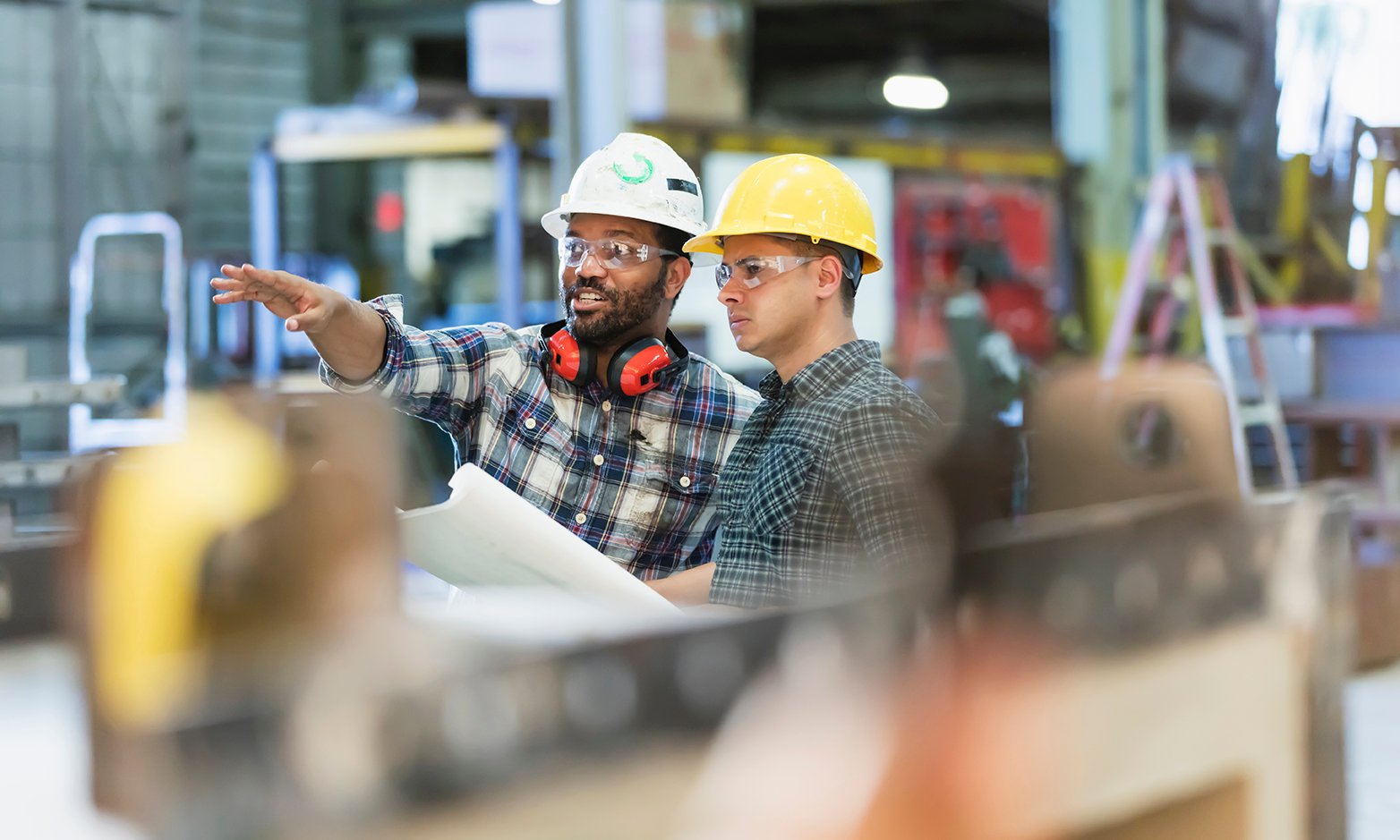 Two skilled labourers discuss work plans.
