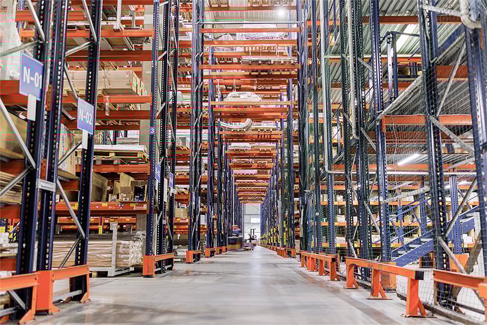 A warehouse with many empty shelves.
