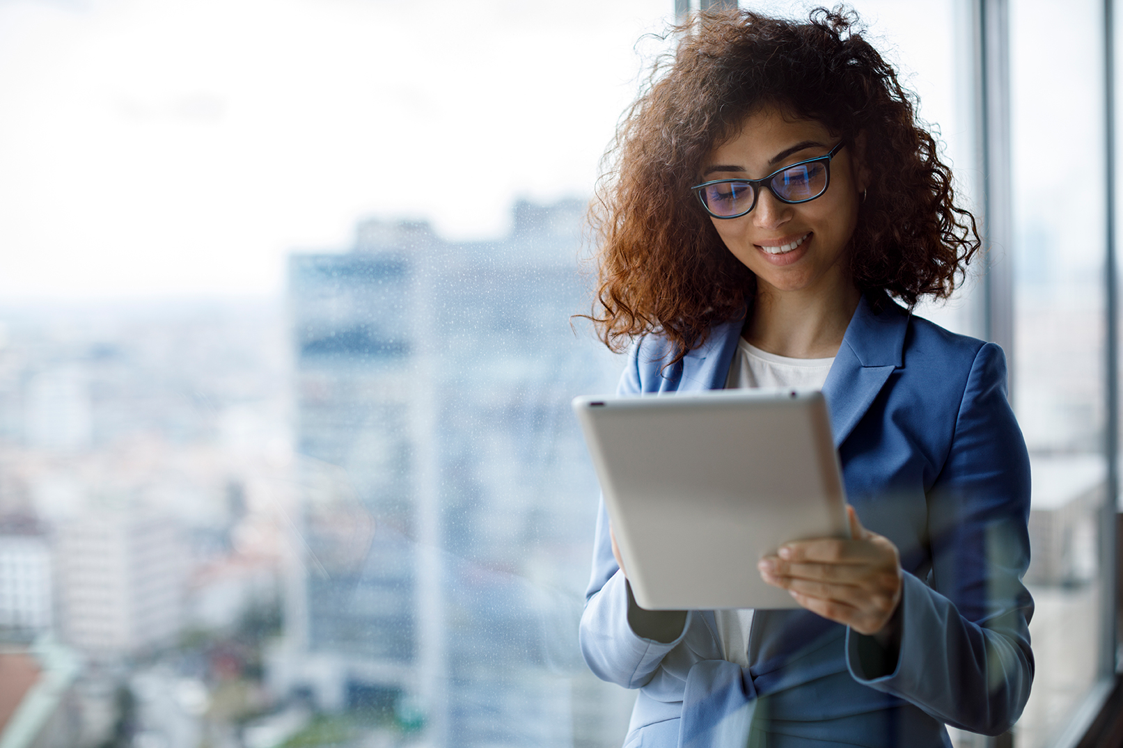 A woman in a blue jack looking at a laptop