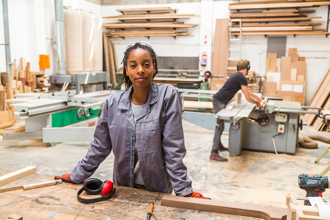 A woman wearing a jumpsuit in a startup workshop