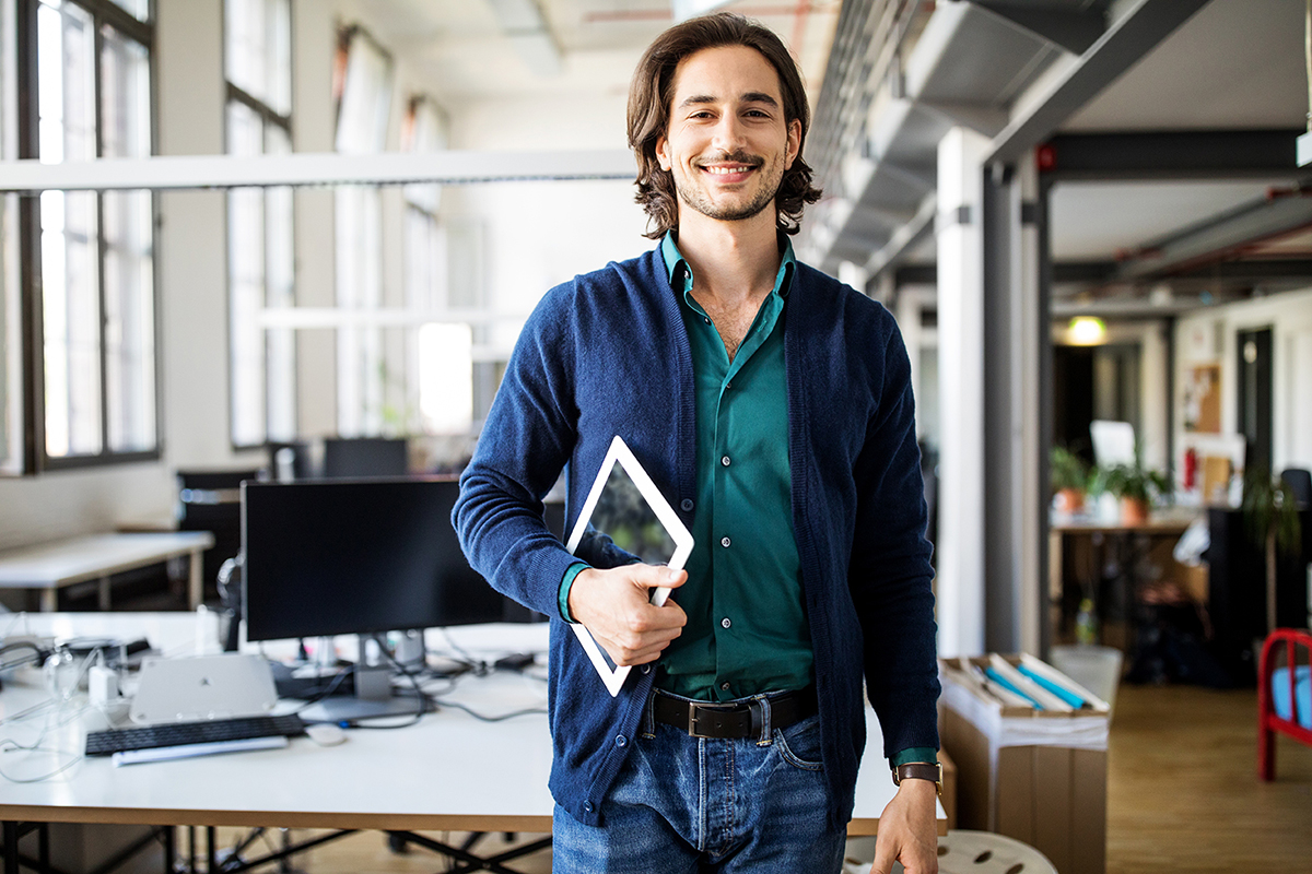 Man in office smiling.