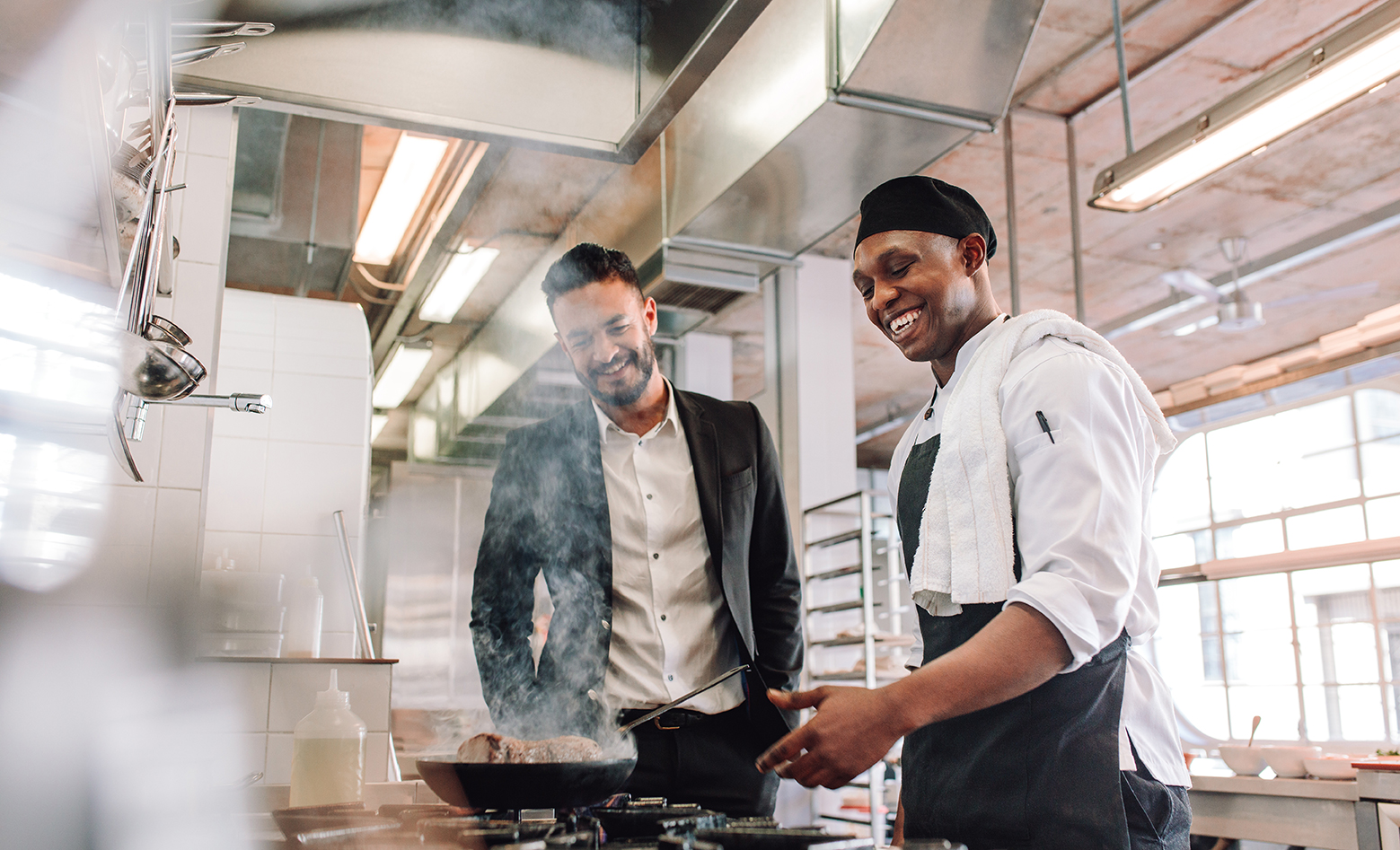 Two men working and smiling after getting a loan