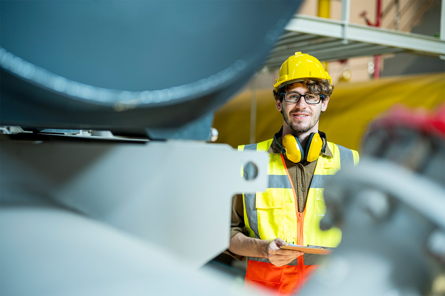 A Cubeler member wearing glasses with a construction helmet and vest